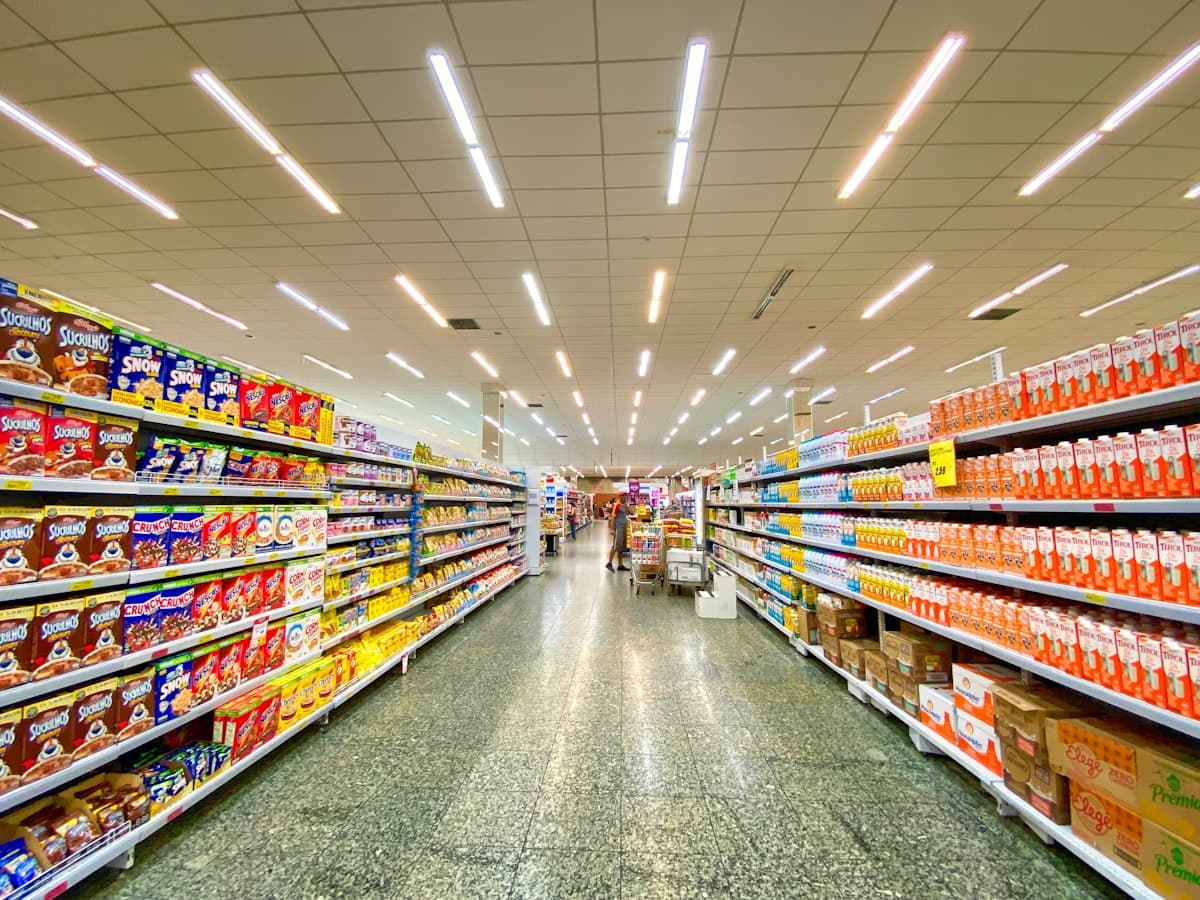 Real supermarket shelves packed with snacks, crisps, and sweets